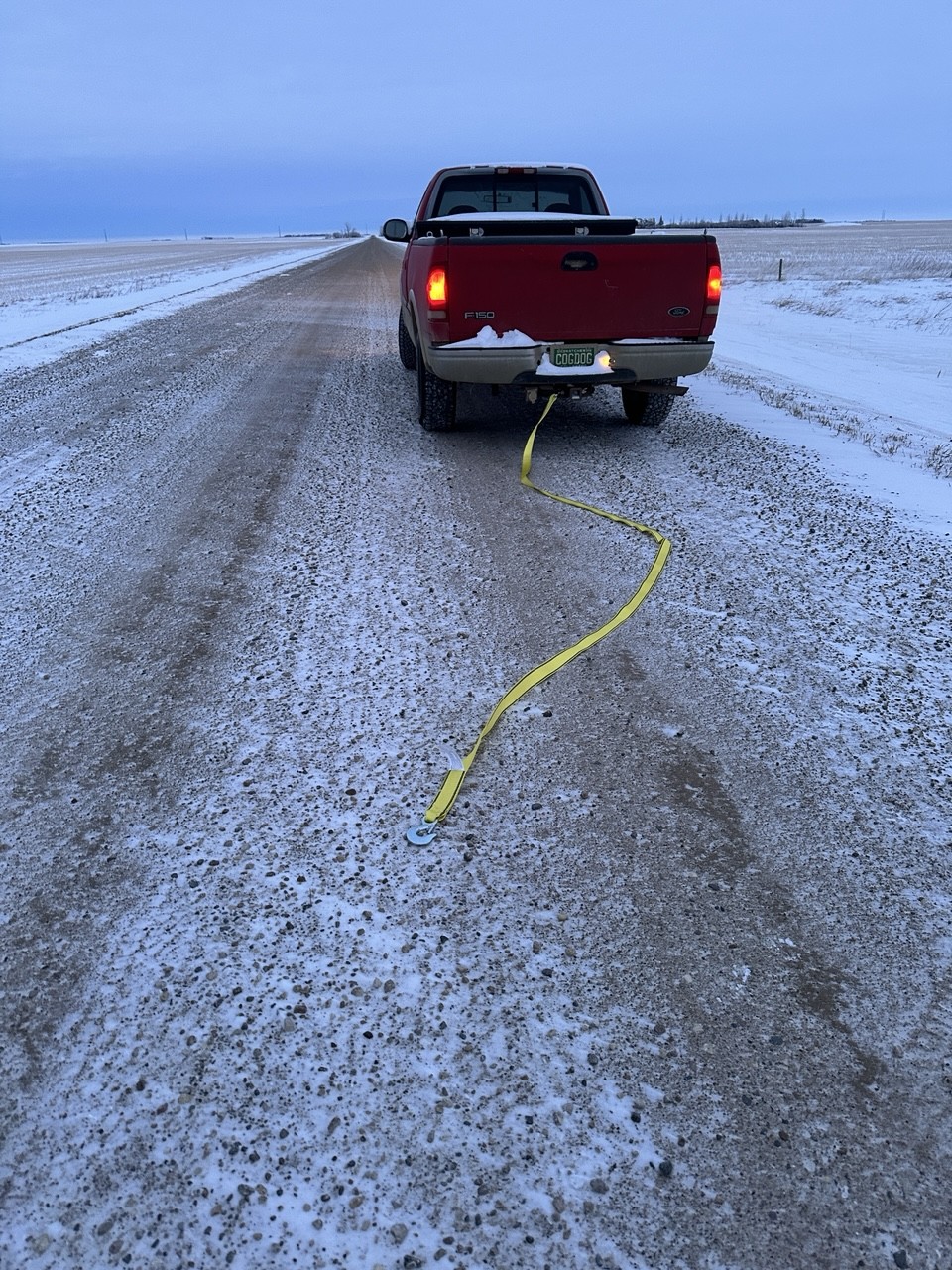 Rear of a 26 year old pick up truck or Ute or half ton depending where in the world you are. Attached to its tow hitch is a 15 for tow strap, minutes after pull my wife’s newer truck back onto the road after it slid into the ditch. 