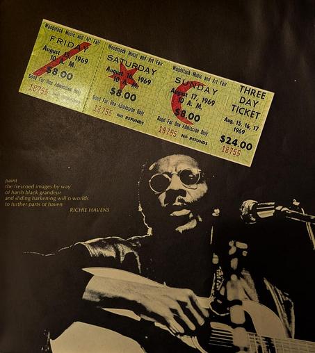 A back-and-white background page with a photo of and lyrical quotation from Richie Havens:

paint
the frescoed images by way
of harsh black grandeur
and sliding harkening will' o worlds
to further parts of haven

Lying on that page, an original three-day ticket to Woodstock Music and Arts fair August 15, 16, 17, 1969. 

Price $24 ($8/day).