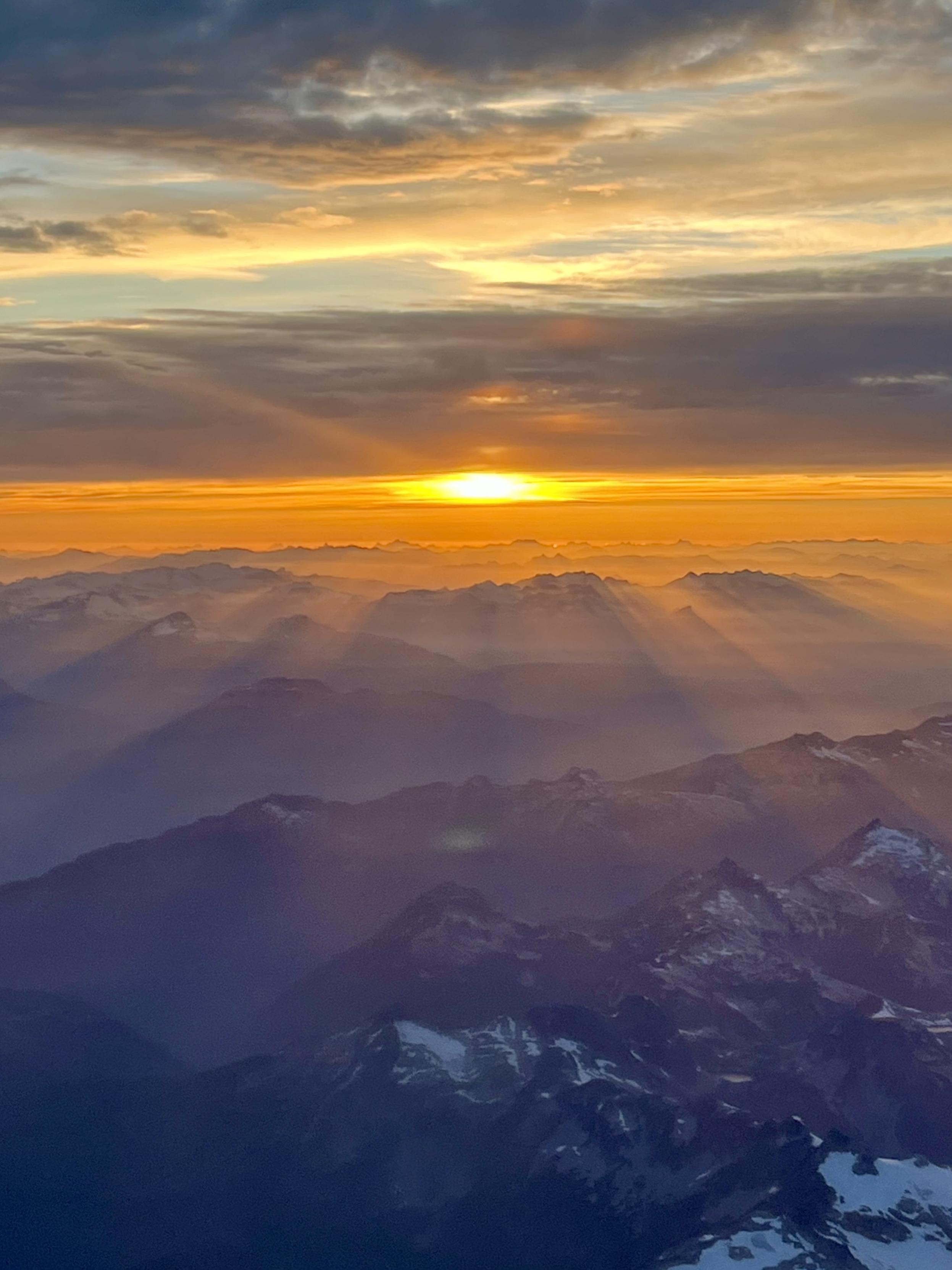 Sunset over the Rockies from an airplane window.